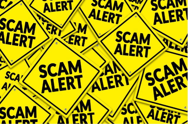 Caution Signs with Scam Alert Message
